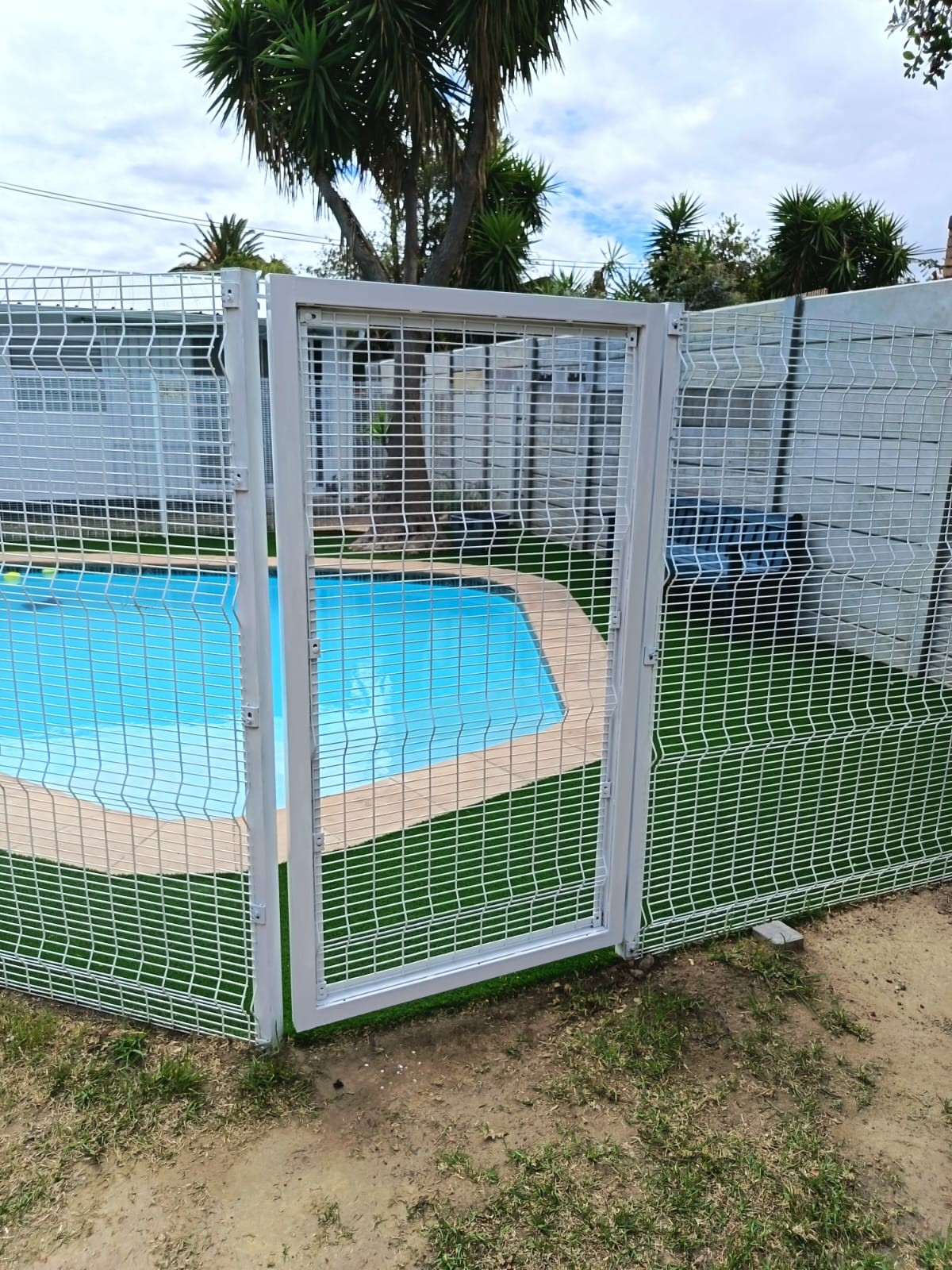 White metal mesh gate and pool fence